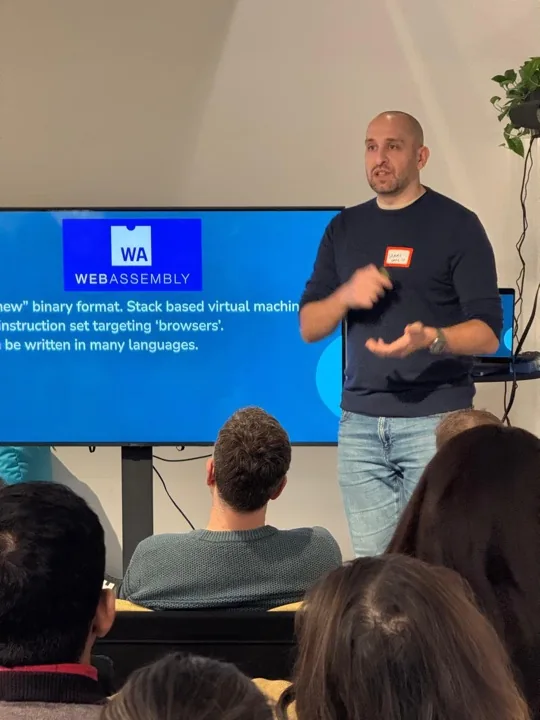 Sammy on stage giving a talk about WebAssembly